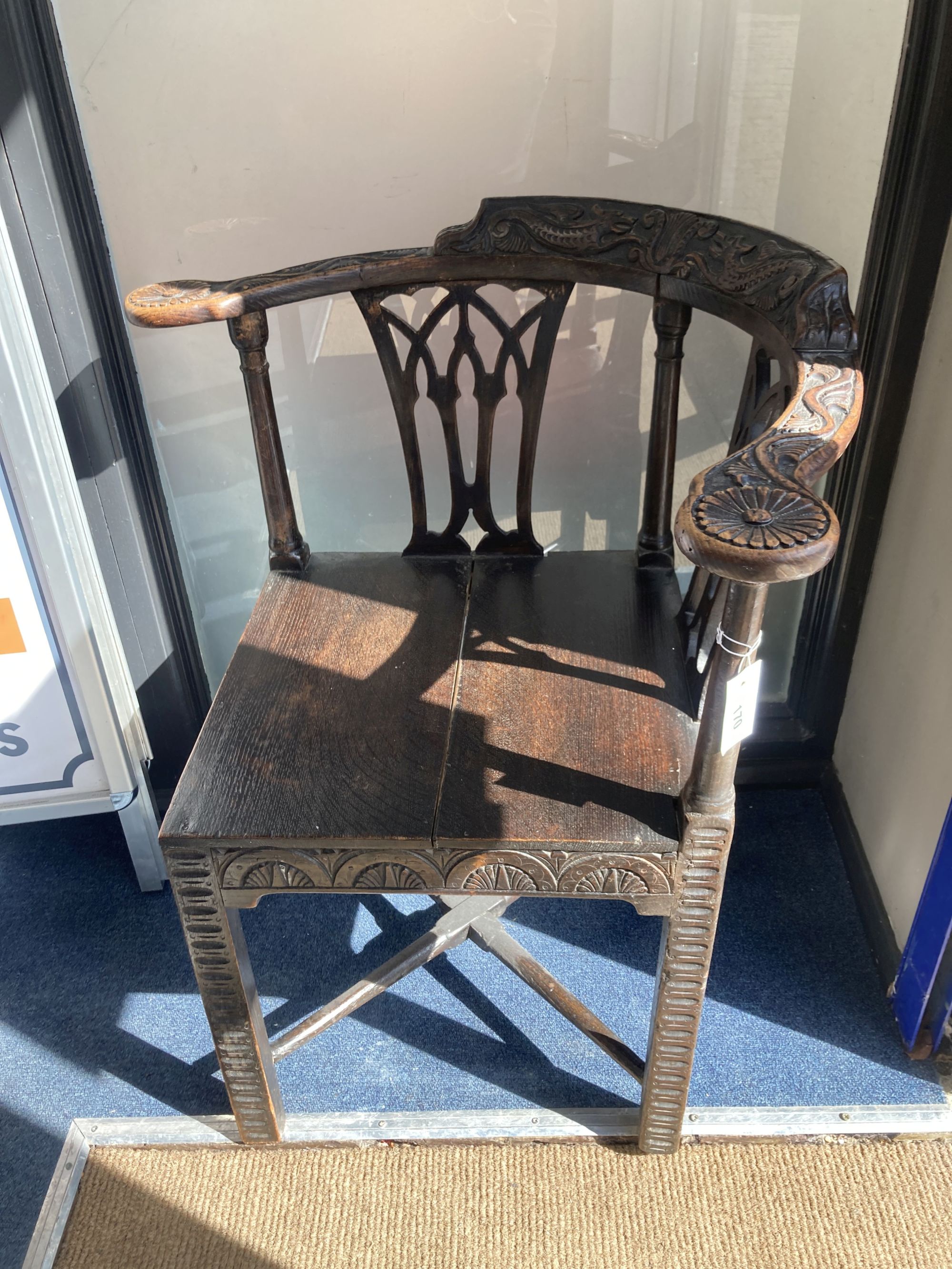 A George III carved mahogany corner elbow chair, width 76cm, depth 64cm, height 82cm